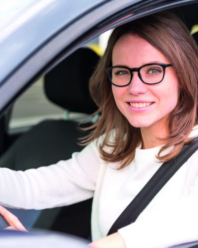 View of a Young attractive woman driving his car
